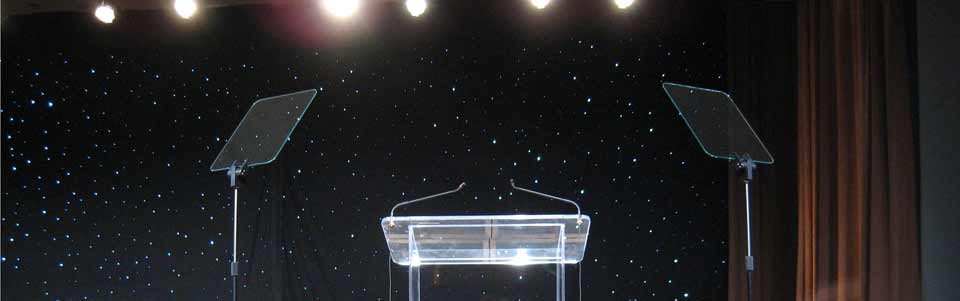 This is a pair of Rise & Fall presidential prompters on the stage during a corporate event.