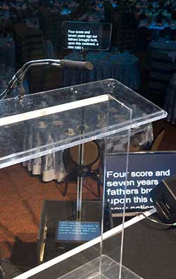 This is a presenter’s view of both types of teleprompting: a rise and fall presidential prompter and a downstage monitor.