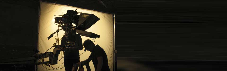 Silhouette of a teleprompter and camera on a jib.
